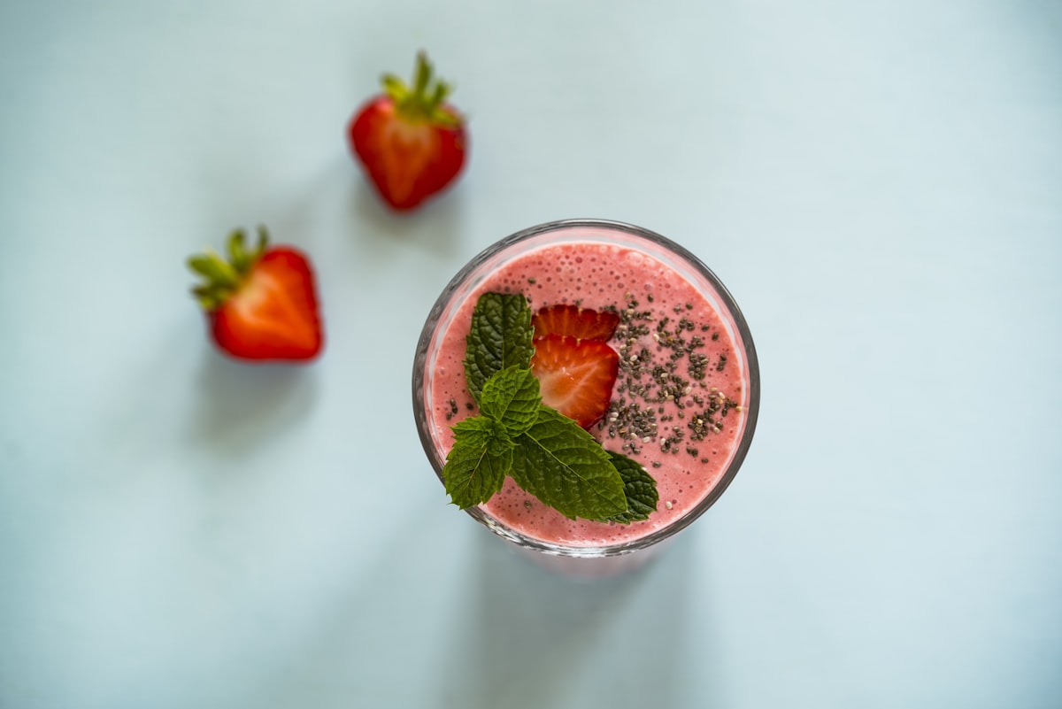 Fresh cold smoothie in glass with fruit